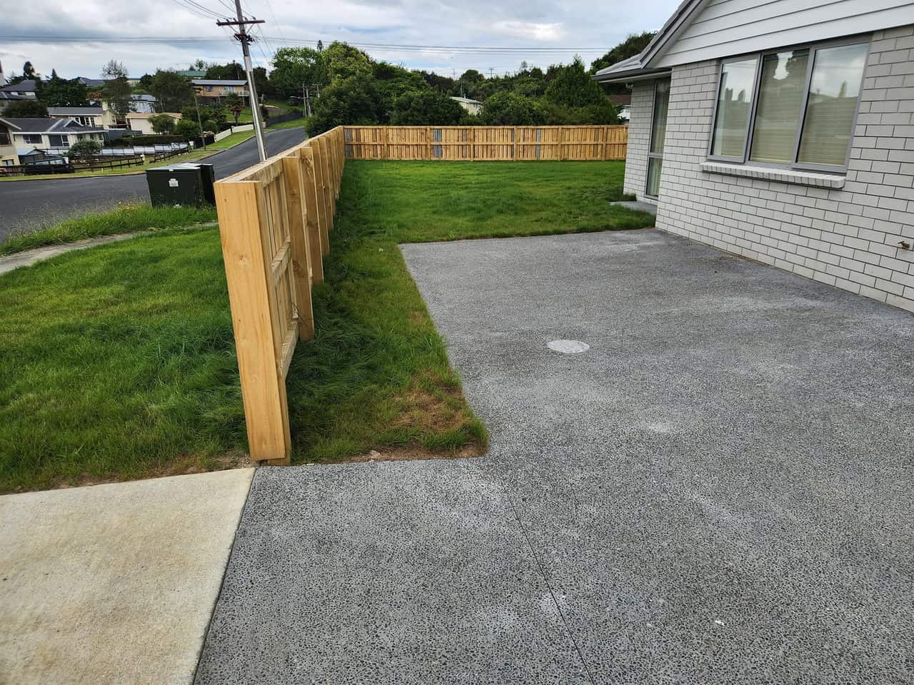 Sharp lawn edges along a fence line in Kihikihi
